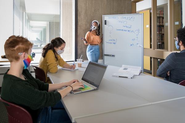 Four students in a study room in Michener Library